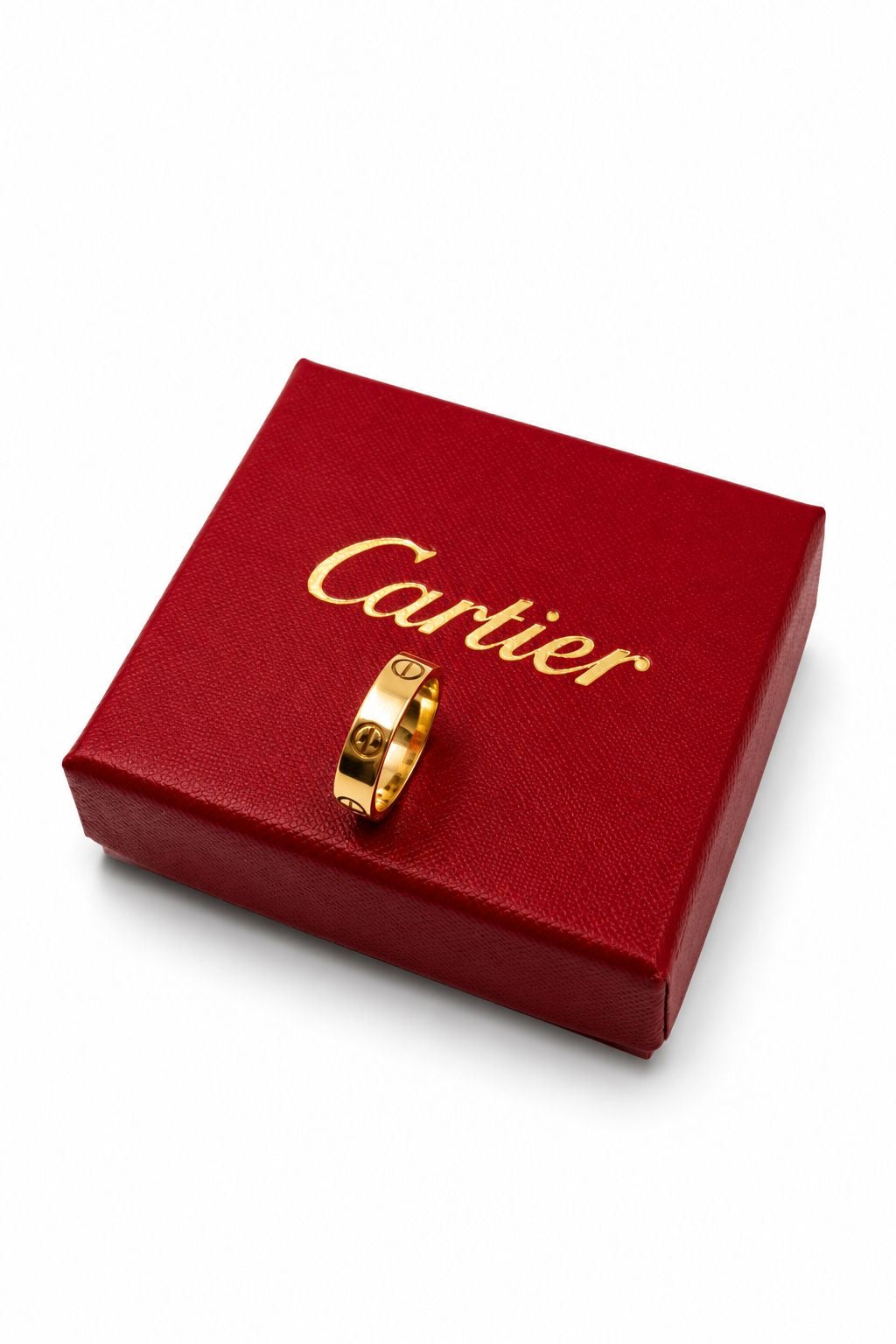 Cartier LOVE wedding band in 18ct yellow gold showing the signature screw motif, angled on a red Cartier presentation box