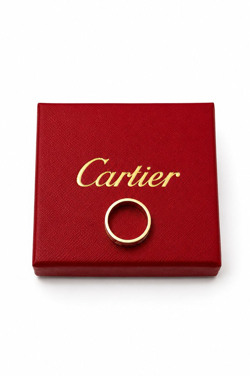Cartier LOVE wedding band in 18ct yellow gold, shown from above on a red Cartier presentation box