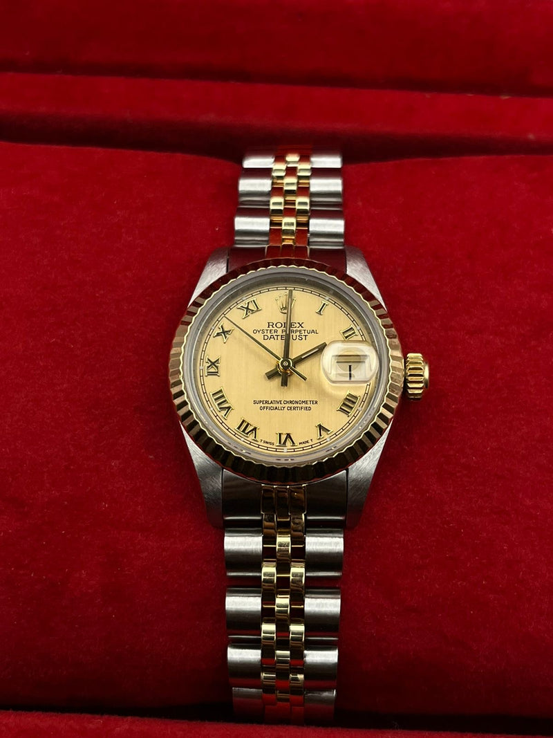 Rolex Lady-Datejust 26mm ref. 69173, close-up of the champagne Roman-numeral dial with fluted gold bezel and two-tone Jubilee bracelet